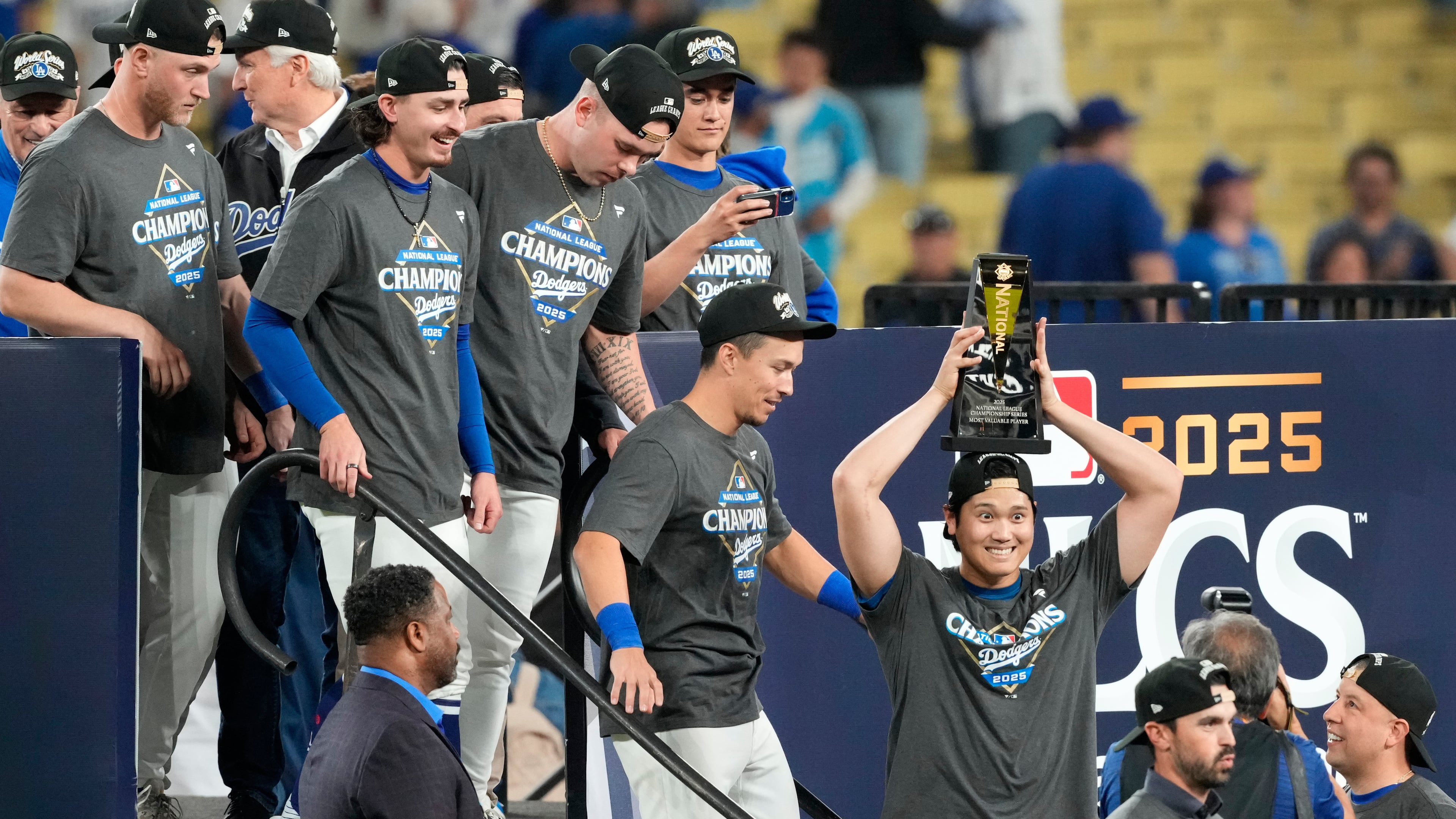 Los Angeles Dodgers' Shohei Ohtani celebrates the the trophy after their win against the Milwaukee Brewers in baseball's National League Championship Series, Friday, Oct. 17, 2025, in Los Angeles. (AP Photo/Mark J. Terrill)