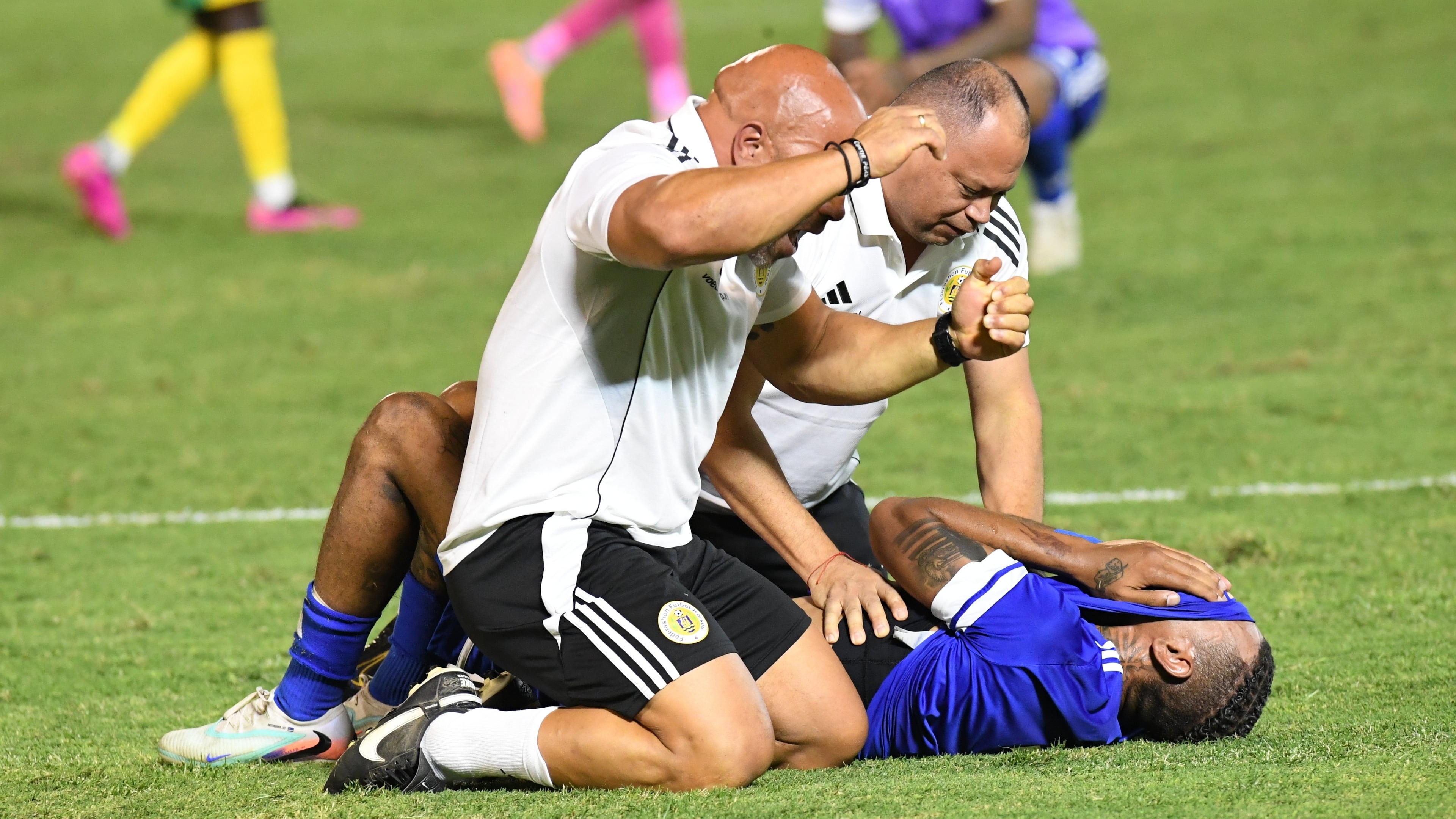 Curacao players and trainers celebrate qualifying for the 2026 FIFA World Cup after their game with Jamaica in Kingston, Jamaica, Tuesday, Nov. 18, 2025. (AP Photo/Collin Reid)