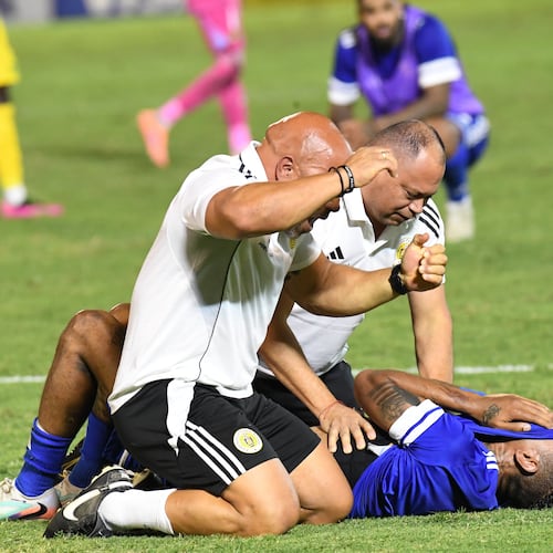Curacao players and trainers celebrate qualifying for the 2026 FIFA World Cup after their game with Jamaica in Kingston, Jamaica, Tuesday, Nov. 18, 2025. (AP Photo/Collin Reid)