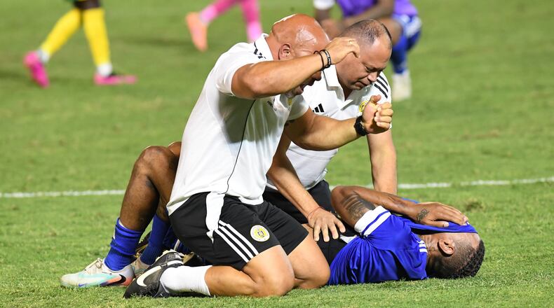 Curacao players and trainers celebrate qualifying for the 2026 FIFA World Cup after their game with Jamaica in Kingston, Jamaica, Tuesday, Nov. 18, 2025. (AP Photo/Collin Reid)