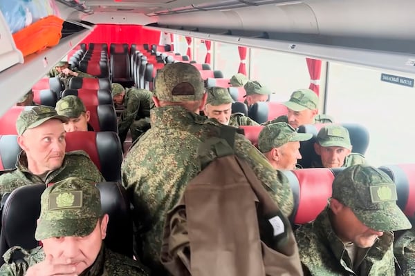 In this photo taken from a video released by Russian Defense Ministry press service, Russian servicemen ride a bus after returning from captivity after an exchange between Russia and Ukraine, at an undisclosed location in Belarus, Saturday, May 24, 2025. (Russian Defense Ministry Press Service via AP)