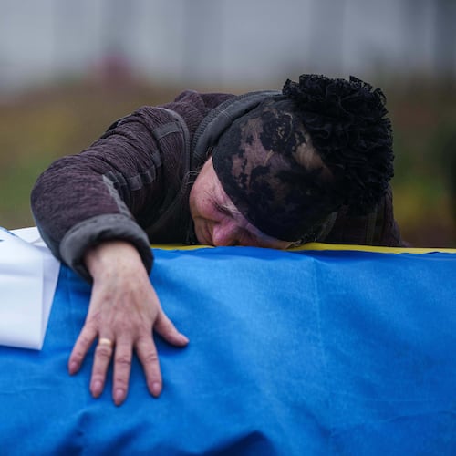 A mother cries at the coffin of her son Oleh Borovyk, a Ukrainian serviceman who was killed in fighting with Russian forces near Pokrovsk, during his funeral ceremony in Boiarka, Ukraine, on Wednesday, Dec. 3, 2025. (AP Photo/Evgeniy Maloletka)