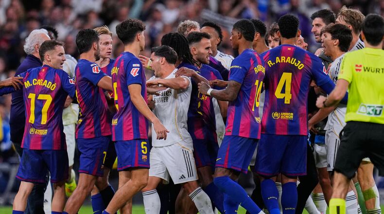Real Madrid and Barcelona players scuffle during the Spanish La Liga soccer match between Real Madrid and Barcelona, in Madrid, Sunday, Oct. 26, 2025. (AP Photo/Manu Fernandez)