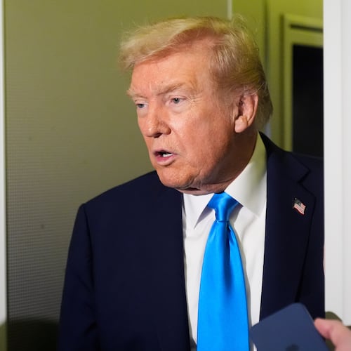 President Donald Trump speaks with reporters aboard Air Force One at Al Udeid Air Base in Doha, Qatar, Saturday, Oct. 25, 2025. (AP Photo/Mark Schiefelbein)