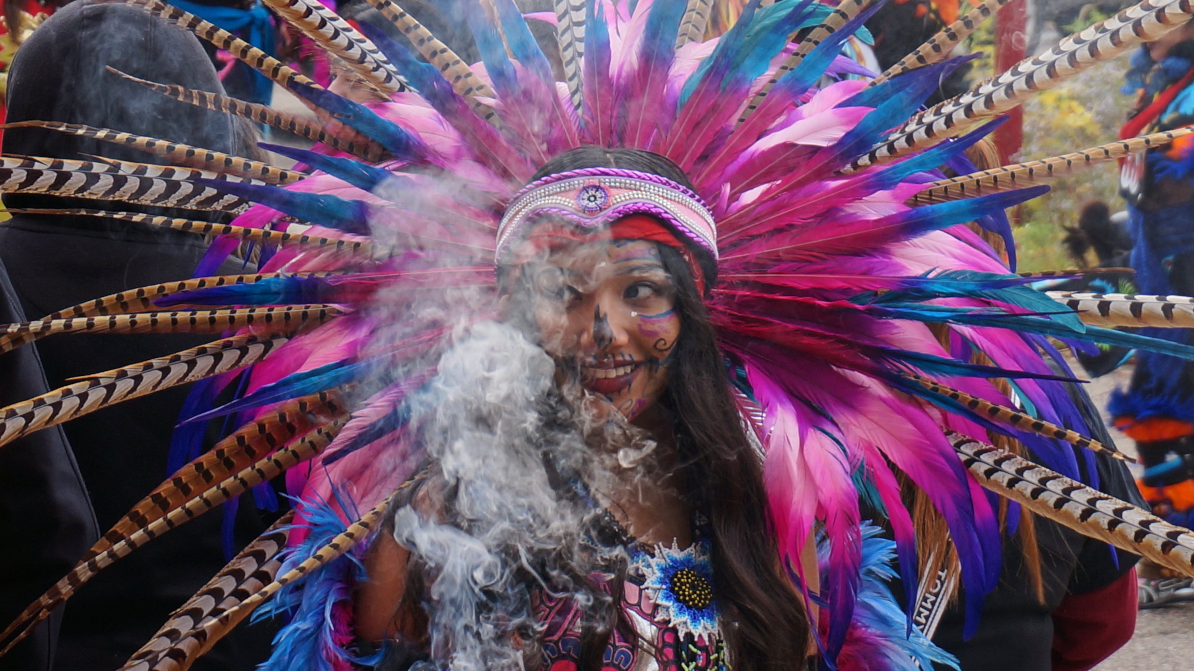 A member of an Aztec dance group holds incense during a commemoration of Día de Muertos (Day of the Dead) at El Colegio High School in Minneapolis on Saturday, Nov. 1, 2025. (AP Photo/Giovanna Dell'Orto)