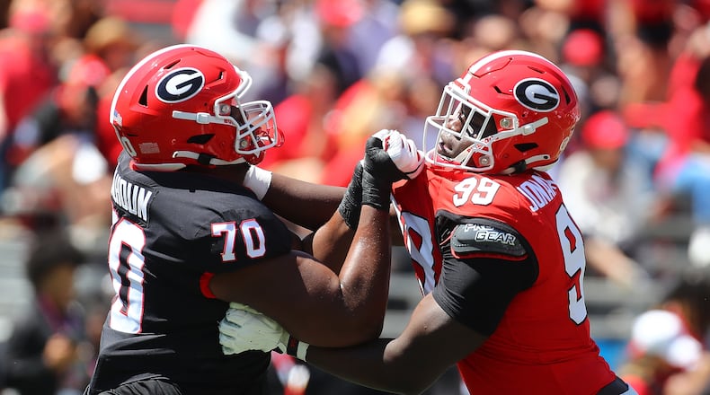 041324 Athens: Georgia offensive lineman Daniel Calhoun (left) takes on defensive lineman Joseph Jonah-Ajonye (right) as the red and black face off during the G-Day game on Saturday, April 13, 2024.  Curtis Compton for the Atlanta Journal Constitution