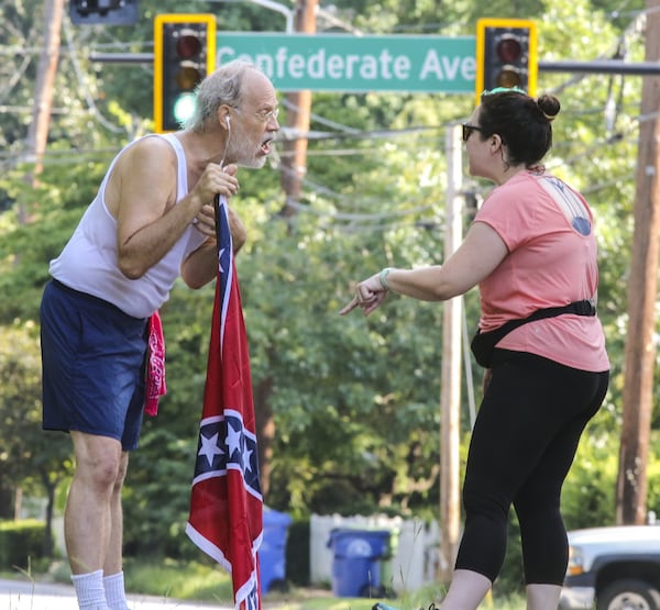 Confederate Flag runner Alan Keck (left) debates Grant Park resident Katie Kurumada about the petition to change the name of Confederate Avenue. Keck, who ran the park three days a week, was concerned about the heritage aspect of Confederate names and symbols. (AJC 2017)