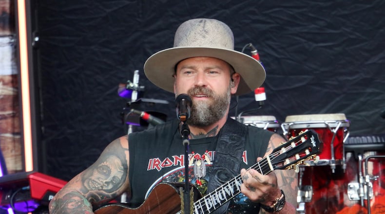 Zac Brown and his band at Atlanta's Truist Park in 2022. They will perform at State Farm Arena on Dec. 31. “It’s always a big night for a party and we decided it was a good time to finish a year that’s had a lot of challenges,” Brown said. “It’s a great reset for everybody.” (AJC 2022)