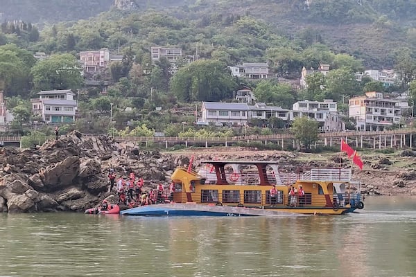 In this photo released by Xinhua News Agency, rescuers carrying out search and rescue operation at the site where two passenger boats capsized in Qianxi City, southwest China's Guizhou Province on Sunday, May 4, 2025. (Xinhua via AP)