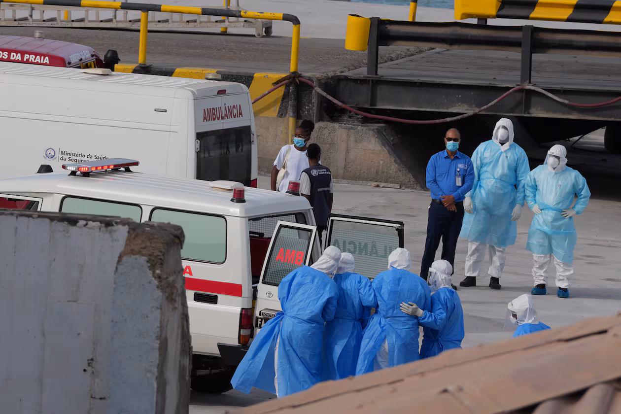 Health workers in protective gear evacuate patients from the MV Hondius cruise ship into an ambulance at a port in Praia, Cape Verde, on Wednesday, May 6, 2026. The luxury liner had eight confirmed cases of hantavirus and two probable cases, according to the WHO. Three people died. (Misper Apawu/AP)