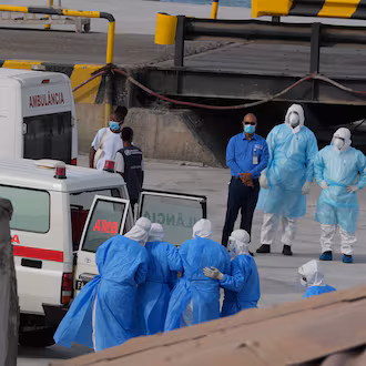 Health workers in protective gear evacuate patients from the MV Hondius cruise ship into an ambulance at a port in Praia, Cape Verde, on Wednesday, May 6, 2026. The luxury liner had eight confirmed cases of hantavirus and two probable cases, according to the WHO. Three people died. (Misper Apawu/AP)