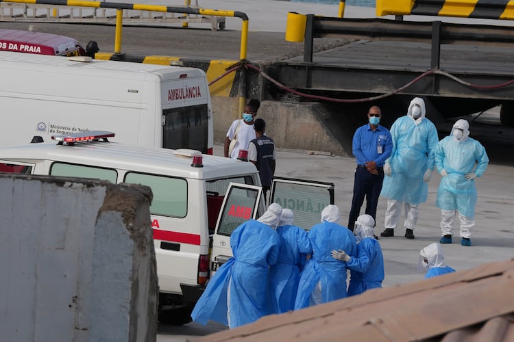 Health workers in protective gear evacuate patients from the MV Hondius cruise ship into an ambulance at a port in Praia, Cape Verde, on Wednesday, May 6, 2026. The luxury liner had eight confirmed cases of hantavirus and two probable cases, according to the WHO. Three people died. (Misper Apawu/AP)