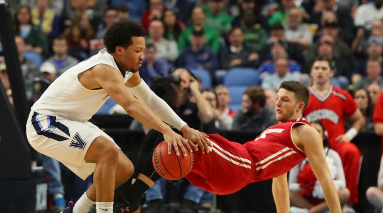 Villanova guard Jalen Brunson (1) is defended by Wisconsin guard Zak Showalter, right, during the first half of a second-round men's college basketball game in the NCAA Tournament, Saturday, March 18, 2017, in Buffalo, N.Y. (AP Photo/Bill Wippert)