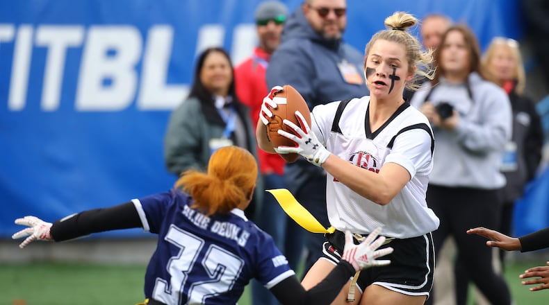 120921 Atlanta: Hillgrove's Lauren Render intercepts Marietta quarterback Claire Hennessey and returns it for a pick six past Marietta defender Marley Quammie in the first half to take a 7-0 lead with the p.a.t. in their GHSA Flag Football Championship Division 3 game on Thursday, Dec 9, 2021, in Atlanta.   “Curtis Compton / Curtis.Compton@ajc.com”`