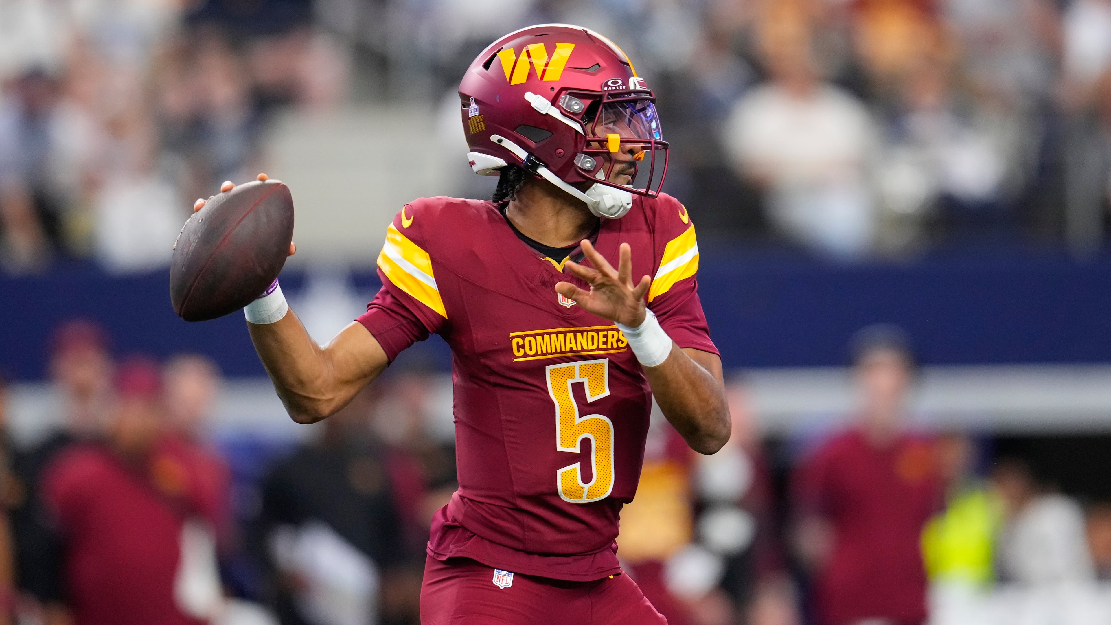Washington Commanders quarterback Jayden Daniels (5) looks to pass against the Dallas Cowboys during the first half of an NFL football game Sunday, Oct. 19, 2025, in Arlington, Texas. (AP Photo/Jeffrey McWhorter)