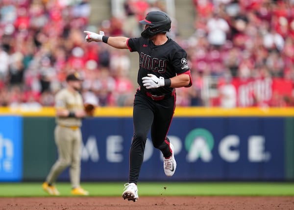 Cincinnati Reds' Spencer Steer gestures as he rounds the bases after hitting a solo home run during the second inning of a baseball game against the San Diego Padres, Friday, June 27, 2025, in Cincinnati. (AP Photo/Jeff Dean)