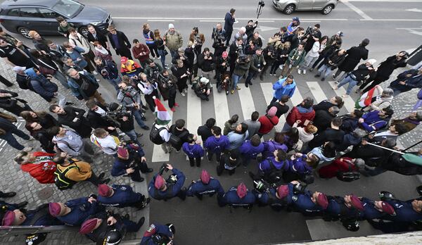 Supporters of the political party Momentum protest at the Hungarian Parliament in Budapest, Monday, April 14, 2025 after Hungary’s parliament has passed an amendment to the constitution that allows the government to ban public events by LGBTQ+ communities. (Tibor Illyes/MTI via AP)