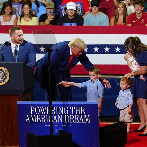 President Donald Trump, center, invites a family on stage to speak about Trump Accounts at Wheeler High School, Wednesday, July 22, 2026, in Marietta, Ga. (AP Photo/Julia Demaree Nikhinson)