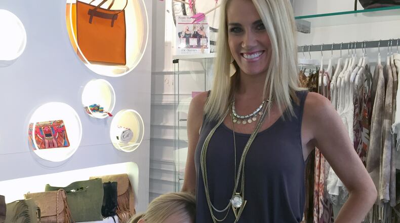 Emily Dees Boulden with her daughter Amzie at her Buckhead boutique Swank. CREDIT: Rodney Ho/ rho@ajc.com