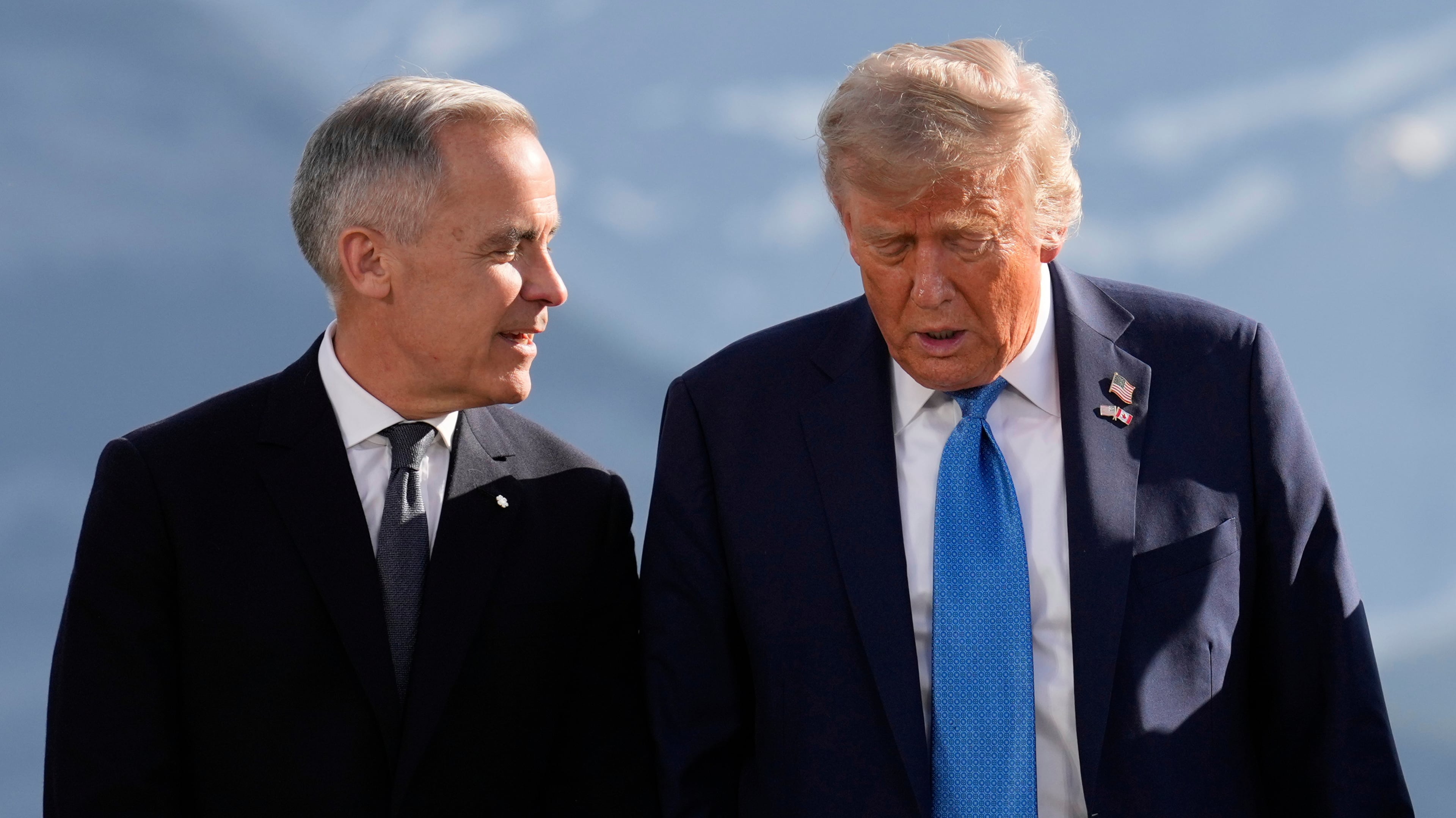 FILE - Canada's Prime Minister Mark Carney talks with President Donald Trump before a group photo at the G7 Summit, June 16, 2025, in Kananaskis, Canada. (AP Photo/Mark Schiefelbein, File)