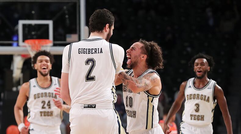 012021 Atlanta: Georgia Tech center Rodney Howard (from left) looks on as Saba Gigiberia gets a chest bump from Jose Alvarado after hitting a three pointer against Clemson in the final minutes of a 83-65 upset victory with Bubba Parham rushing to join the celebration in an NCAA college basketball game on Tuesday, Jan. 20, 2021, in Atlanta. At left Clemson forward PJ Hall looks on. Curtis Compton / Curtis.Compton@ajc.com”