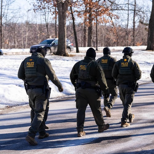 FILE - U.S. Border Patrol officers walk along a street in Minneapolis, Wednesday, Jan. 14, 2026. (AP Photo/Adam Gray,File)