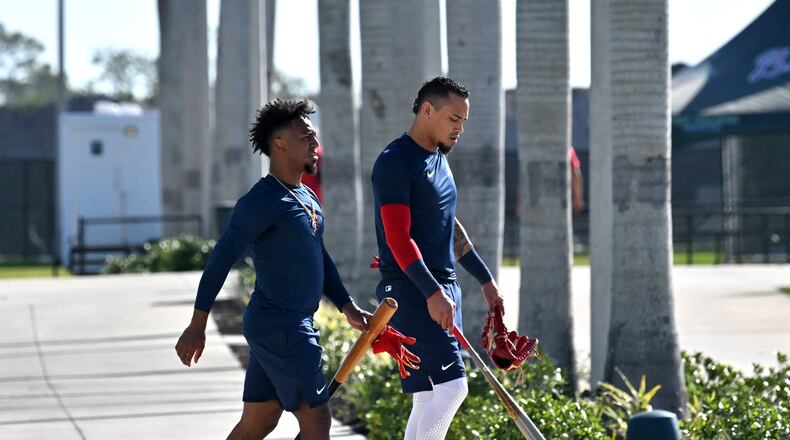 Atlanta Braves second baseman Ozzie Albies (left) and second baseman Orlando Arcia walk back to the clubhouse after taking batting practice during Braves spring training at CoolToday Park, Thursday, Feb. 16, 2023, in North Port, Fla.. (Hyosub Shin / Hyosub.Shin@ajc.com)