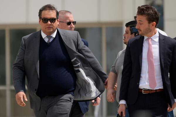 Former U.S. Rep. George Santos, left, leaves federal court after being sentenced to more than seven years in prison for fraud and identity theft, Friday, April 25, 2025, in Central Islip, N.Y. (AP Photo/Julia Demaree Nikhinson)