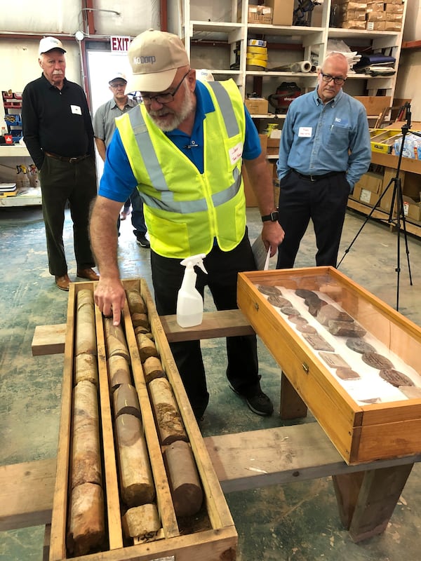 FILE - NioCorp Corporate Controller Jeff Mason shows investors core samples the mining company has collected while NioCorp CEO Mark Smith listens, Oct. 6, 2021 in Elk Creek, Neb. (AP Photo/Josh Funk, File)