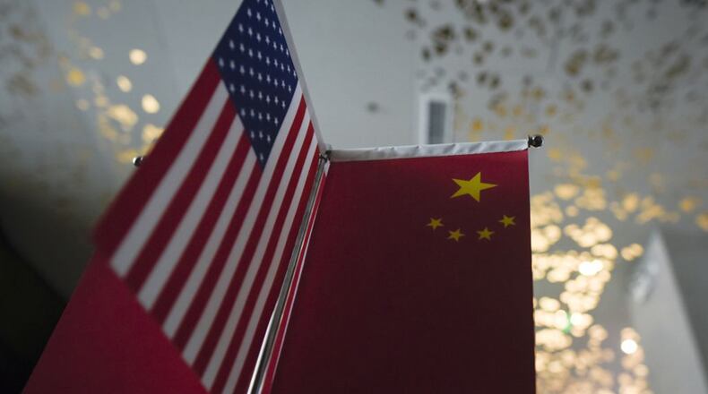 Chinese flags and American flags are displayed in a company in Beijing on Aug. 16, 2017. (Photo by WANG ZHAO/AFP via Getty Images/TNS)