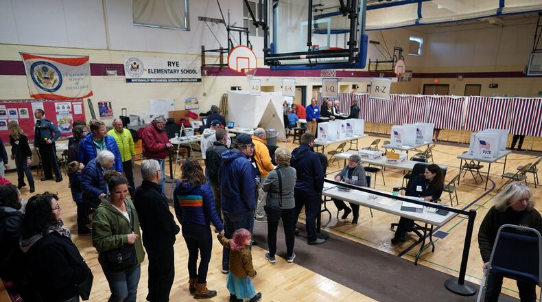 People arrive to vote at Rye Elementary School in Rye, N.H., on Tuesday. New Hampshire voters are weighing in on an unsettled Democratic presidential field in the first-in-the-nation primary. (Chang W. Lee/The New York Times)