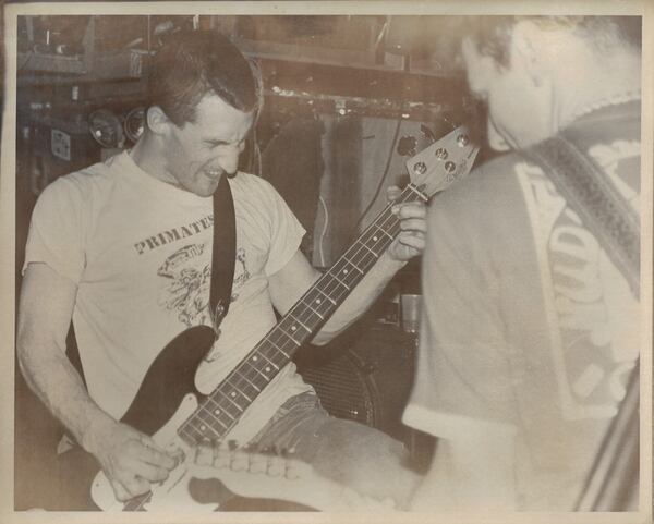 A vintage photograph of David Barbe on bass (facing camera in mid-tortured artist punk rock expression) with Andrew Donaldson on guitar, during a Mercyland show from the late '80s. (Courtesy of David Barbe)