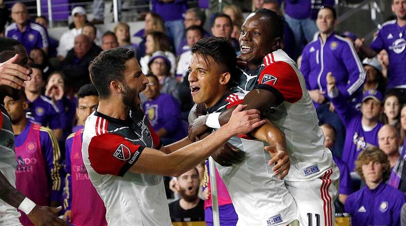 Mar 3, 2018; Orlando, FL, USA; D.C. United midfielder Yamil Asad (22) celebrates with forward Darren Mattocks (11) and teammates as he scores as goal against the Orlando City during the first half at Orlando City Stadium. Mandatory Credit: Kim Klement-USA TODAY Sports
