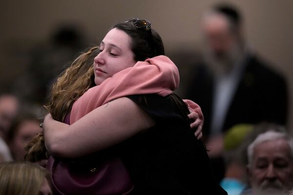 People at the Jewish Community Center of Greater Kansas City morn Sarah Milgrim and Yaron Lischinsky, Israeli Embassy staff members who were shot and killed while leaving an event at a Jewish museum in Washington, Thursday, May 22, 2025, in Overland Park, Kan. (AP Photo/Charlie Riedel)