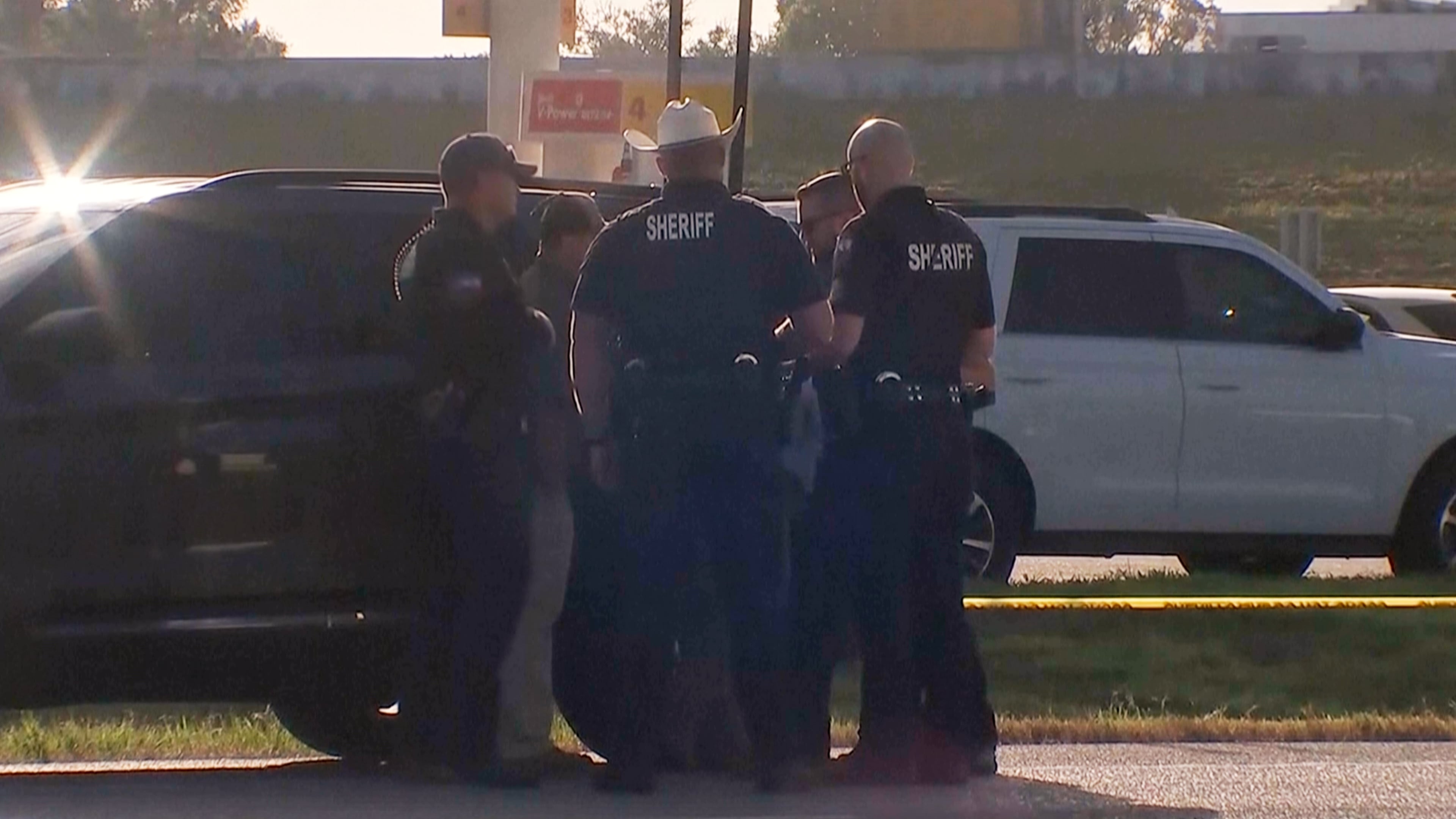 Law enforcement officials investigate a vehicle near the scene of a deadly shooting shooting early Saturday, Oct. 4, 2025 in the Houston suburb of Angleton, Texas. (KTRK via AP)