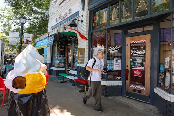A pedestrian walks in front of Paolo's Gelato and Pielands Sub & Slice on Virginia Avenue on May 15, 2026. (Arvin Temkar/AJC)