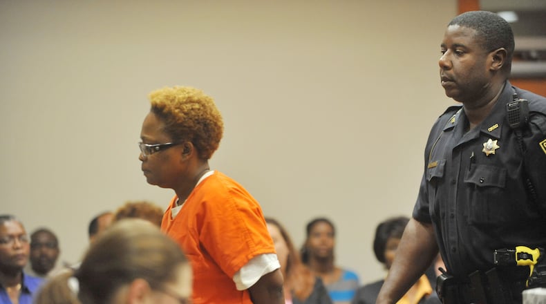 Pamela Ballin is escorted out of court in a 2014 hearing.