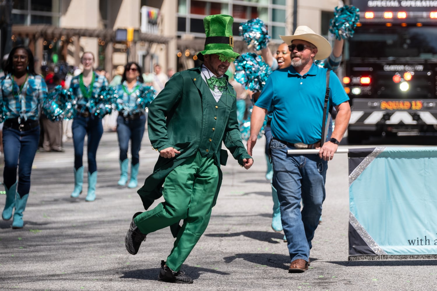 Ian Mack, with Georgia Boots Belles and Beaus, runs along during the Atlanta St. Patrick’s Parade on Saturday, March 14, 2026. (Ben Gray for the AJC)