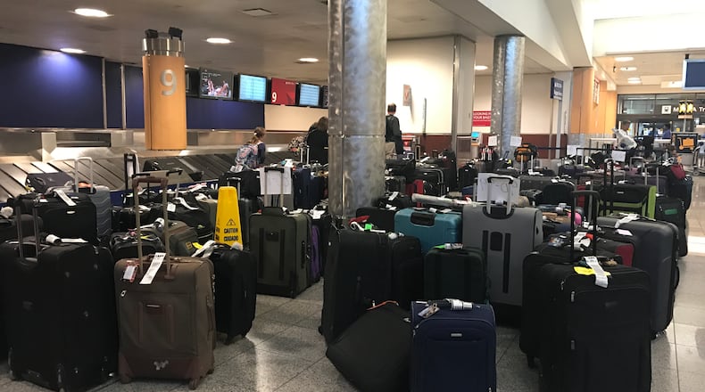 Hundreds of bags were left on the floor at Delta baggage claim at the Atlanta airport in the aftermath of the airline's thousands of flight cancellations since Wednesday.