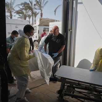 Bodies of unidentified Palestinians returned from Israel as part of the ceasefire deal are brought to Nasser Hospital in Khan Younis, Gaza Strip, Wednesday Nov. 5, 2025. (AP Photo/Jehad Alshrafi)