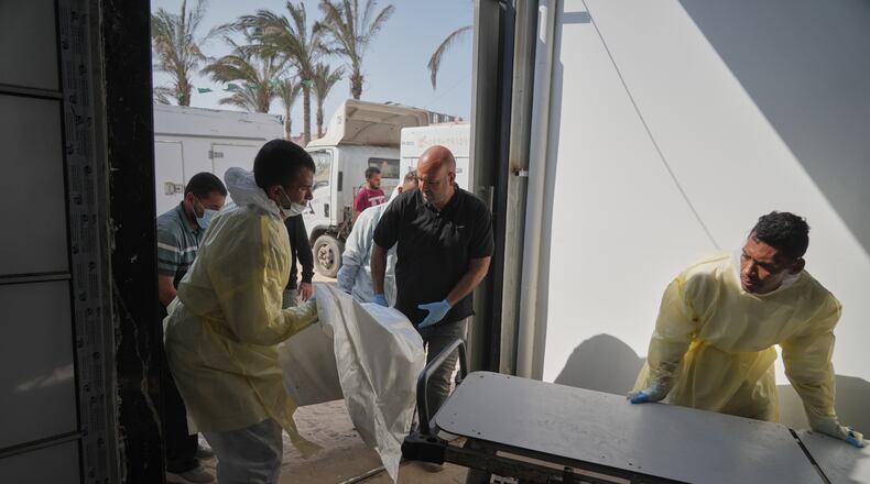 Bodies of unidentified Palestinians returned from Israel as part of the ceasefire deal are brought to Nasser Hospital in Khan Younis, Gaza Strip, Wednesday Nov. 5, 2025. (AP Photo/Jehad Alshrafi)