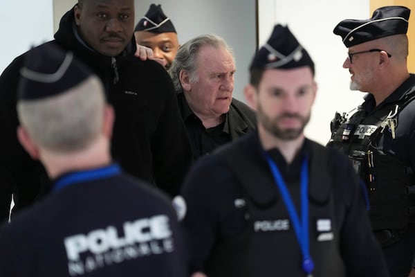 Actor Gerard Depardieu, center, returns to the courtroom after a break for his trial for the alleged sexual assaults of two women on a film set in 2021, Tuesday, March 25, 2025 in Paris. (AP Photo/Aurelien Morissard)