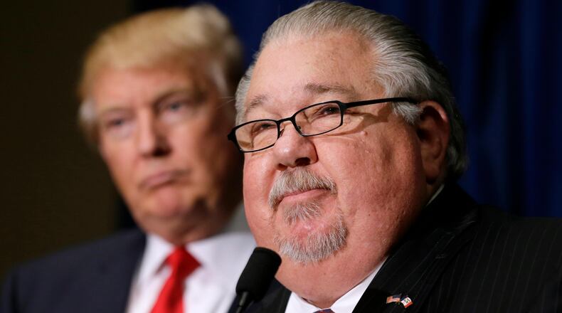 In this Aug. 25, 2016, file photo, Sam Clovis speaks during a news conference as then-Republican presidential candidate Donald Trump, left, watches before a campaign rally in Dubuque, Iowa. Clovis, a former Trump campaign official who has been linked to the investigation by special counsel Robert Mueller, has withdrawn his nomination for an Agriculture post. (AP Photo/Charlie Neibergall)