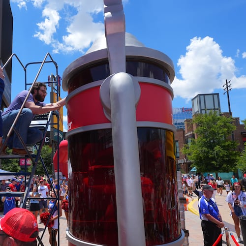 Eric Johnson and Guinness World Records adjudicator Thomas Bradford check the level of beer before certifying a world record for Largest Glass of Beer ahead of a baseball game between the Detroit Tigers and Texas Rangers, Saturday, July 4, 2026, in Arlington, Texas. (AP Photo/LM Otero)