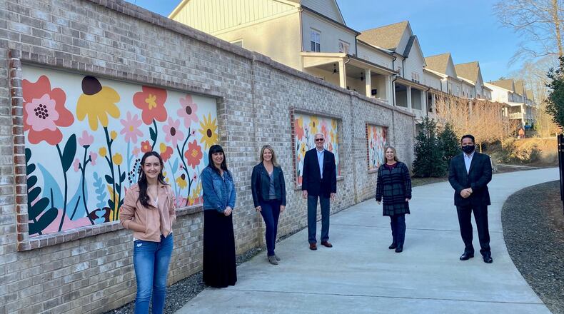 From left, artist Cecilia Gonzalez, Cultural Services Coordinator Meghan Vilela, Cultural Services Manager Kim Zane, Parks, Recreation and Cultural Services Director Morgan Rodgers, fundraiser Diane Grecco, and City Councilman Donald Mitchell with the new mural installed along the AlphaLoop west of the Thompson Street Park and alongside the Midwick neighborhood. (Courtesy City of Alpharetta)