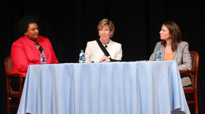 Democratic candidates for governor Stacey Abrams (left) and Stacey Evans (right) with moderator Cathy Cox appear in their first forum since announcing their candidacies on Monday, Oct. 2, 2017, at The Carter Center in Atlanta. Curtis Compton/ccompton@ajc.com