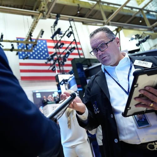 Edward Curran, right, works on the floor at the New York Stock Exchange in New York, Monday, Sept. 14, 2026. (AP Photo/Seth Wenig)