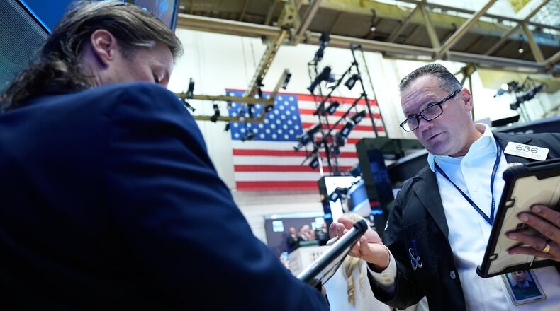 Edward Curran, right, works on the floor at the New York Stock Exchange in New York, Monday, Sept. 14, 2026. (AP Photo/Seth Wenig)