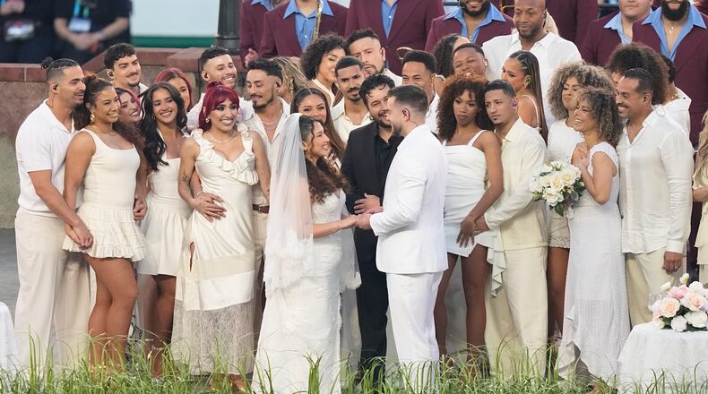 A couple dressed as a bride and groom participate in the Bad Bunny performance during halftime of the NFL Super Bowl 60 football game between the Seattle Seahawks and the New England Patriots, Sunday, Feb. 8, 2026, in Santa Clara, Calif. (AP Photo/Frank Franklin II)