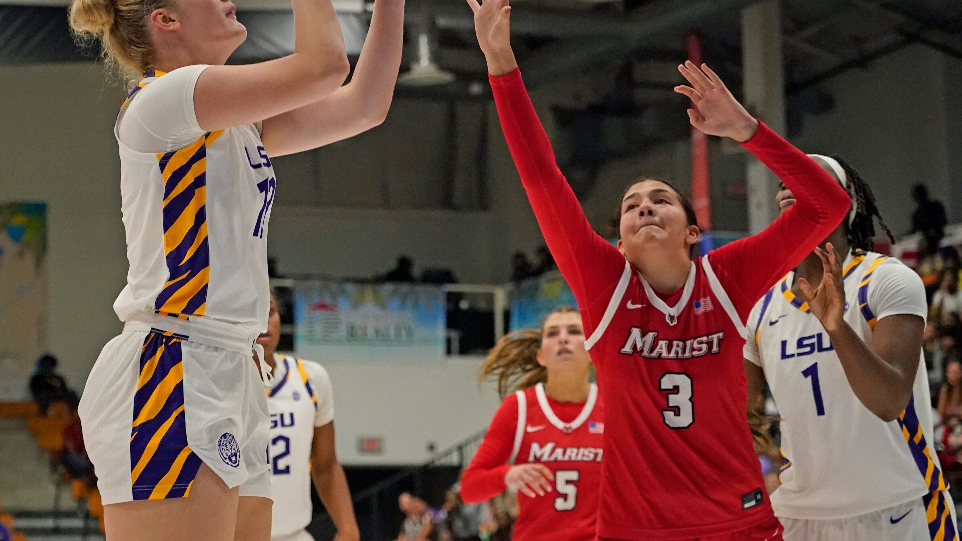 LSU forward Kate Koval, left, looks to shoot a jump shot over Marist guard Justine Henry (3) during the second quarter of an NCAA college basketball game at the Paradise Jam tournament Friday, Nov. 28, 2025, in St. Thomas, U.S. Virgin Islands. (Bill Kiser/The Virgin Islands Daily News via AP)